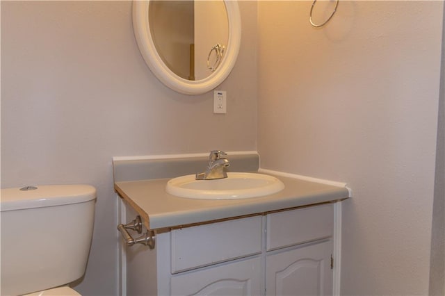 bathroom featuring vanity and toilet