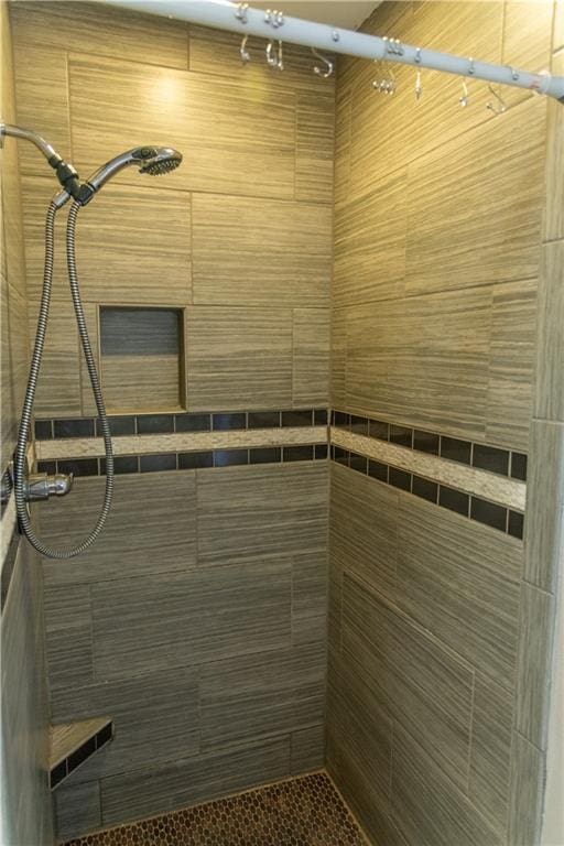 bathroom with a tile shower