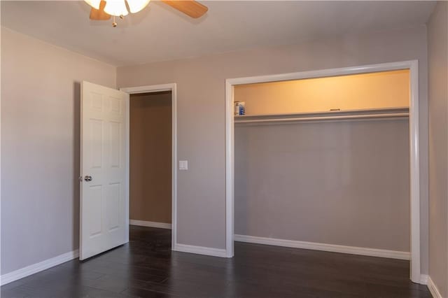 unfurnished bedroom with dark wood-type flooring, a closet, and ceiling fan