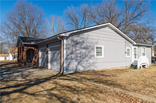 view of property exterior featuring a garage and a lawn