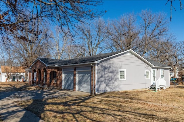 view of side of property with a garage and a lawn