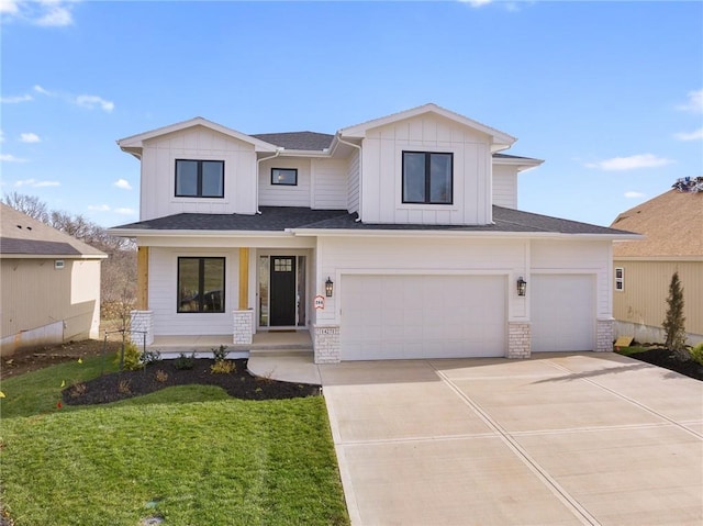 view of front of property featuring a garage and a front yard