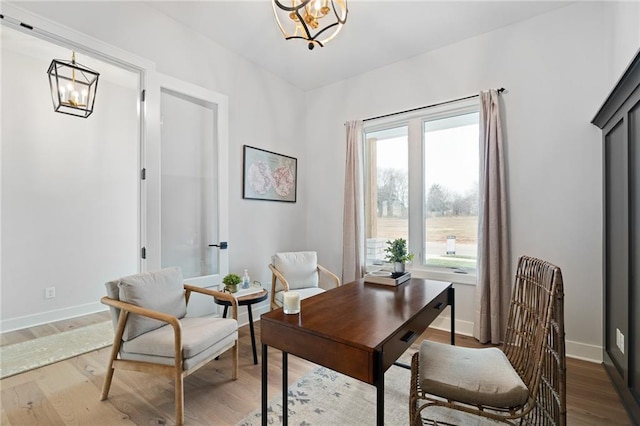 home office with hardwood / wood-style flooring and a chandelier