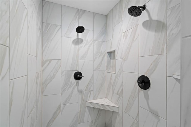 interior details featuring a tile shower