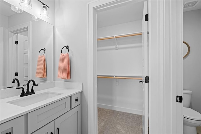 bathroom with vanity and toilet