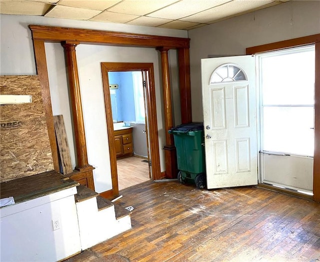 foyer featuring a drop ceiling and dark wood-type flooring