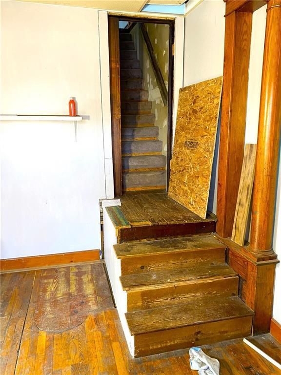 stairs with hardwood / wood-style floors