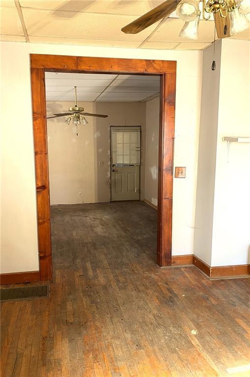 spare room featuring ceiling fan and dark hardwood / wood-style flooring