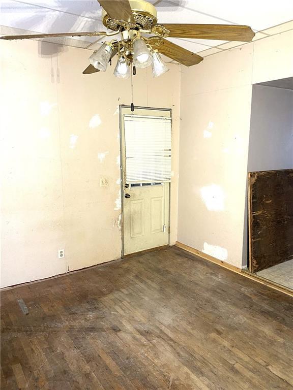 unfurnished room featuring hardwood / wood-style floors and ceiling fan