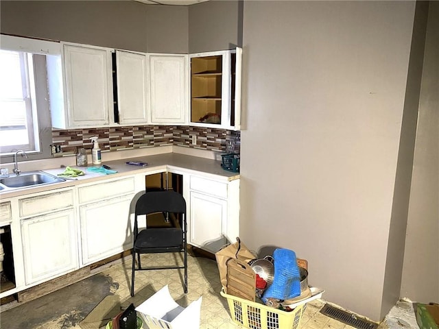 bathroom with tasteful backsplash and sink