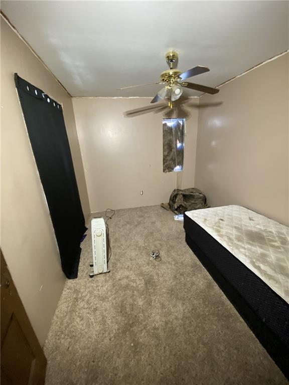 bedroom with ceiling fan and carpet flooring