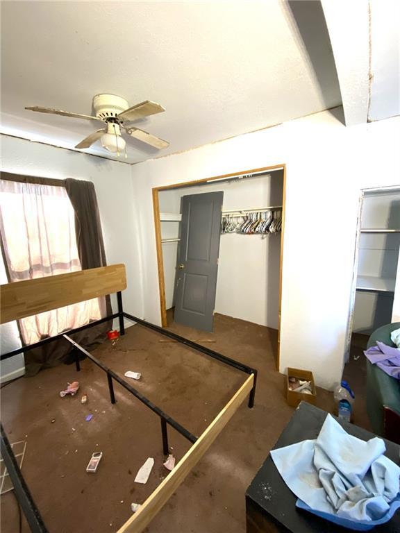 bedroom with ceiling fan and a closet