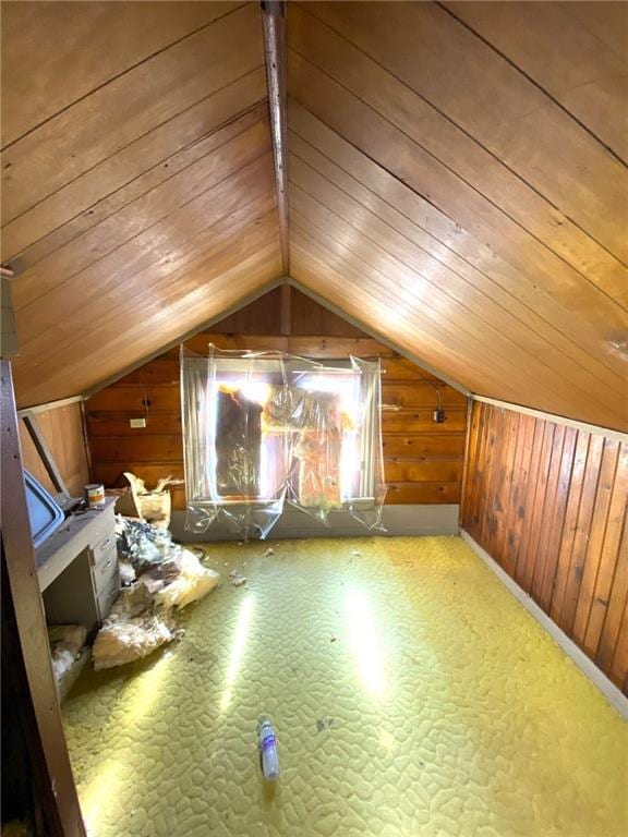 additional living space featuring wooden ceiling, vaulted ceiling, and wood walls