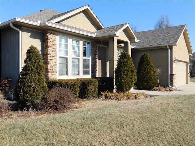 view of home's exterior featuring a garage and a yard