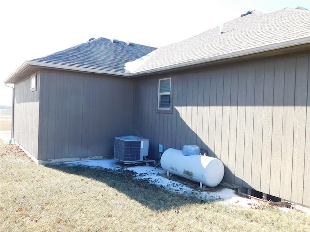 view of home's exterior featuring cooling unit and a lawn