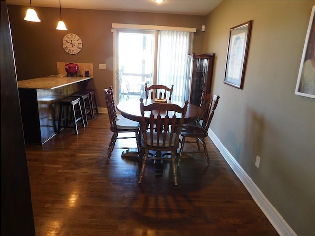 dining space with dark hardwood / wood-style floors