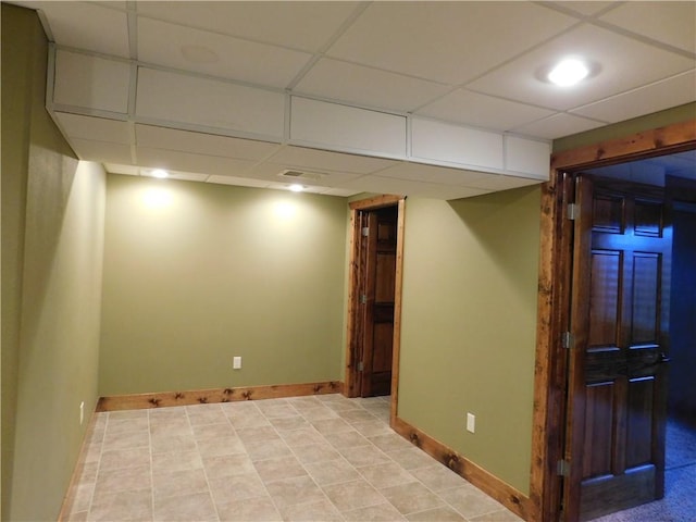 basement with a paneled ceiling