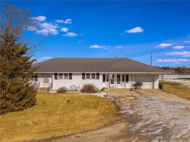 ranch-style home with a garage and a front yard