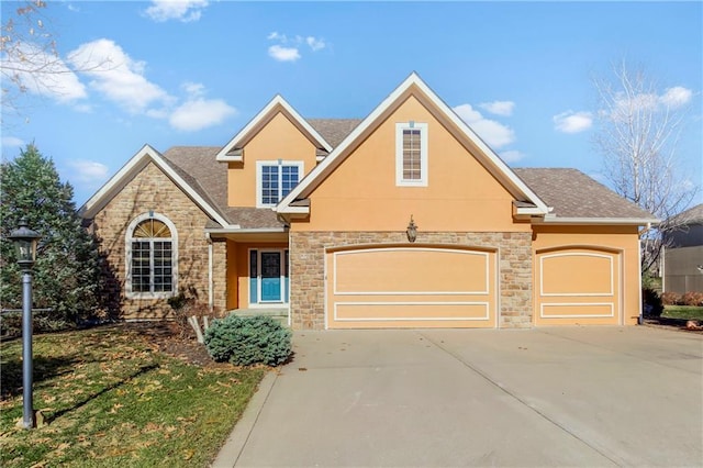 traditional-style house featuring stucco siding, a garage, concrete driveway, and a shingled roof