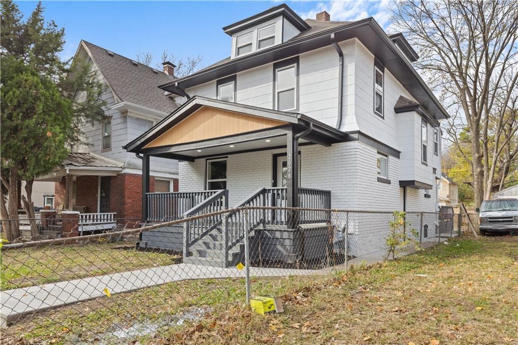 view of front of home with a porch and a front yard