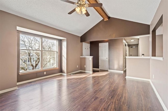 unfurnished living room with lofted ceiling with beams, ceiling fan, a textured ceiling, and dark hardwood / wood-style flooring