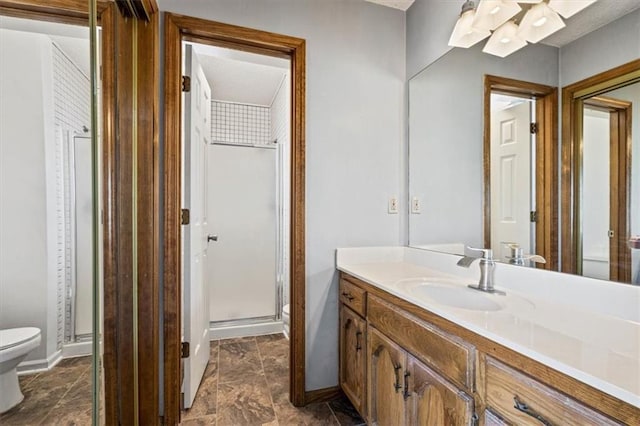 bathroom with vanity, an enclosed shower, and toilet