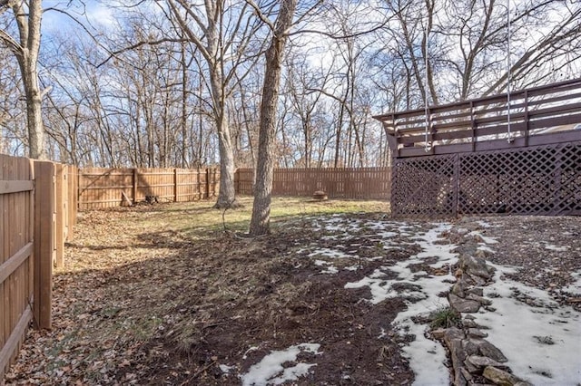 snowy yard with a wooden deck