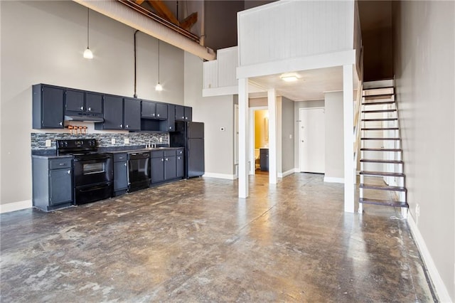 kitchen with decorative backsplash, a high ceiling, hanging light fixtures, black appliances, and blue cabinetry