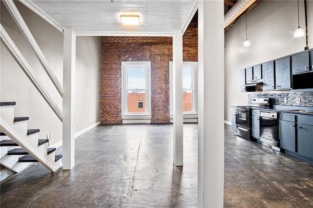 interior space featuring dishwasher, brick wall, pendant lighting, and stainless steel electric range