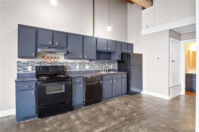 kitchen with a towering ceiling, blue cabinets, sink, hanging light fixtures, and black appliances