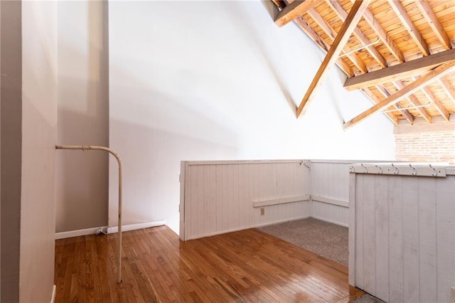 interior space featuring wood-type flooring, vaulted ceiling with beams, and wood ceiling