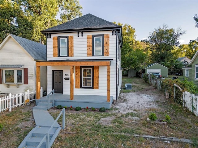 view of front of property featuring a porch, a garage, and central AC unit