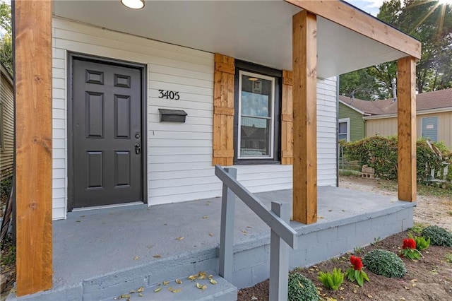 view of exterior entry with covered porch