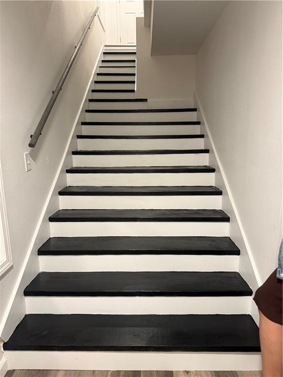 staircase featuring wood finished floors
