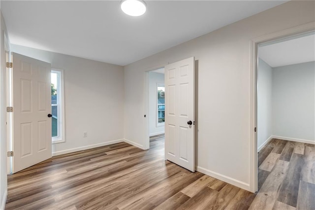 entrance foyer featuring baseboards and wood finished floors