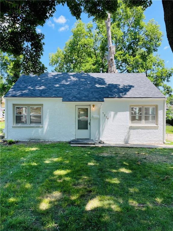 rear view of house with a yard