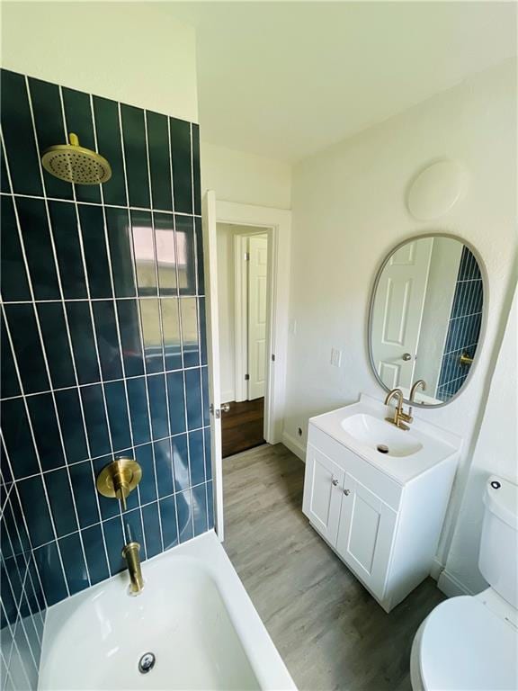 bathroom with vanity, toilet, and hardwood / wood-style floors