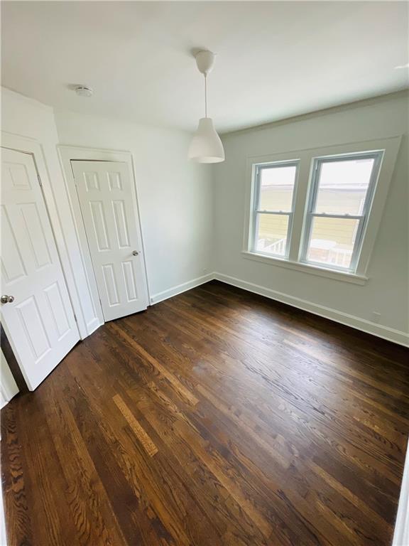 unfurnished dining area featuring dark hardwood / wood-style flooring