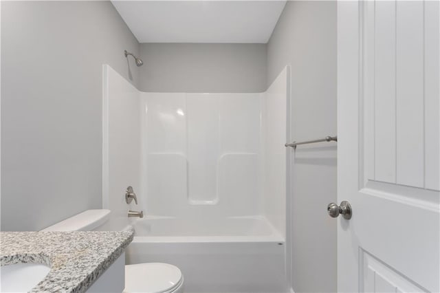 bathroom featuring toilet, shower / tub combination, and vanity