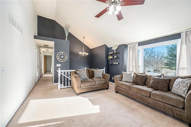 carpeted living room featuring lofted ceiling and ceiling fan with notable chandelier