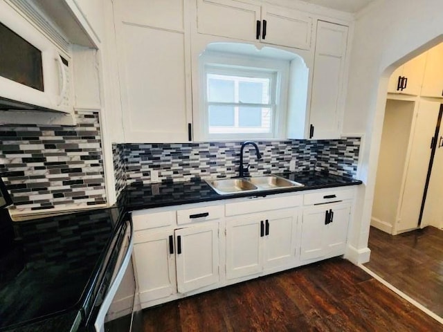 kitchen featuring white cabinetry, sink, backsplash, and dark hardwood / wood-style floors