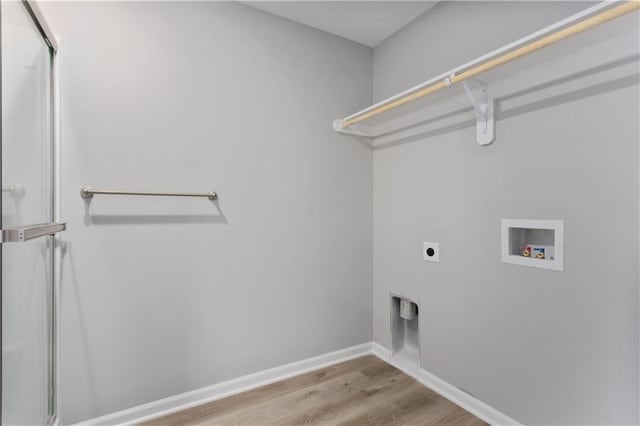 washroom with hookup for an electric dryer, hookup for a washing machine, and light hardwood / wood-style flooring