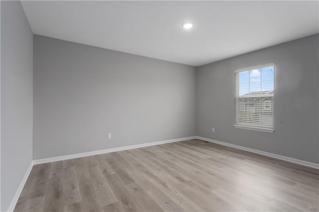 spare room with light wood-type flooring