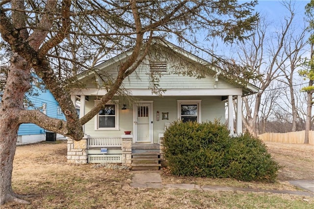 bungalow-style house with central AC and a porch