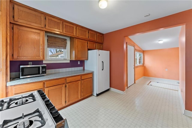 kitchen with white appliances and light stone countertops