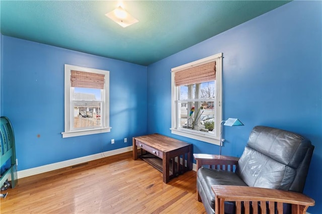 sitting room with a healthy amount of sunlight and light hardwood / wood-style floors