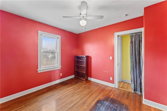 unfurnished room featuring wood-type flooring and ceiling fan