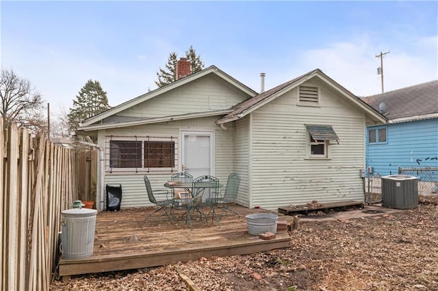 rear view of property featuring a wooden deck and central AC