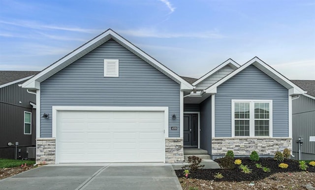 view of front of property with a garage and central air condition unit