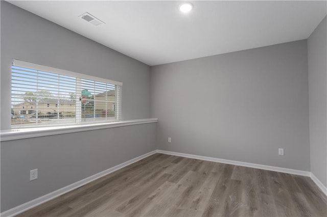 spare room with hardwood / wood-style flooring